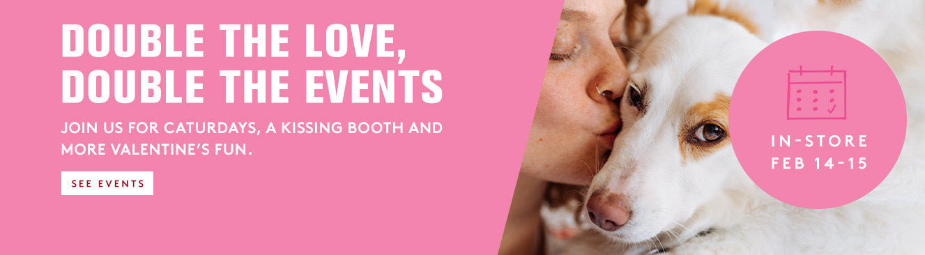 Promotional banner for a pet store event with a dog and a person, featuring text about cat-friendly Saturdays and kissing booths.